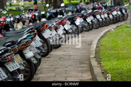 Motorbikes in a park in Ho Chi Minh City Vietnam Shallow depth of field with only the nearest bikes in focus Stock Photo