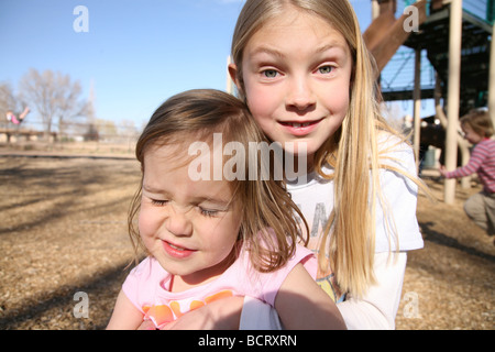 Portrait of two sisters playing in garden Stock Photo