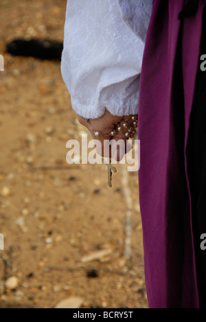 woman holding rosary by lake in her hand Stock Photo