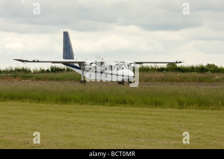 Britten-Norman BN2A Islander G-AWNT starting take-off run at Wickenby Airfield Stock Photo