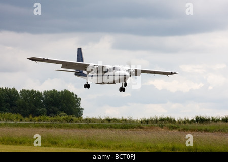 Britten-Norman BN2A Islander G-AWNT on final approach to land at Wickenby Airfield Stock Photo