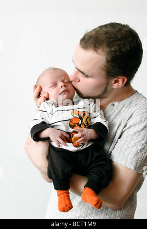 nineteen year old teenage father holds his newborn baby boy Stock Photo