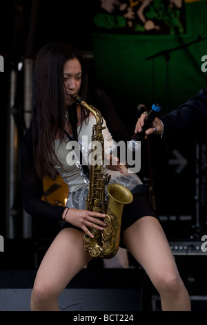 japanese oriental woman saxophonist jazz ska band Lambeth Country Show, Brockwell Park, Tulse Hill, London, England, UK, Europe Stock Photo