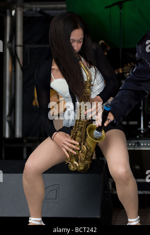 japanese oriental woman saxophonist jazz ska band Lambeth Country Show, Brockwell Park, Tulse Hill, London, England, UK, Europe Stock Photo