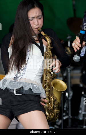 japanese oriental woman saxophonist jazz ska band  Lambeth Country Show, Brockwell Park, Tulse Hill, London, England, UK, Europe Stock Photo