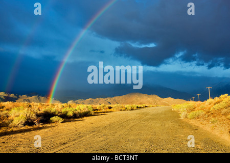 Rainbow over Eastern Sierra Mountains near Bishop California Stock Photo