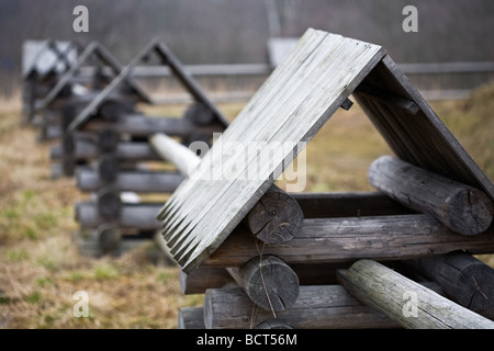 village fence made from wooden logs with small turrets in Russian style Stock Photo