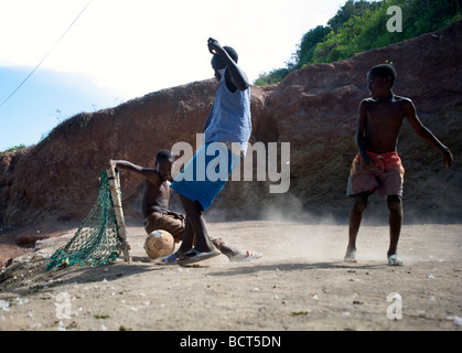 Children play a game of football (soccer) in the Carenage neighborhood on the north end of Cap Haitien, Haiti on July 26, 2008. Stock Photo