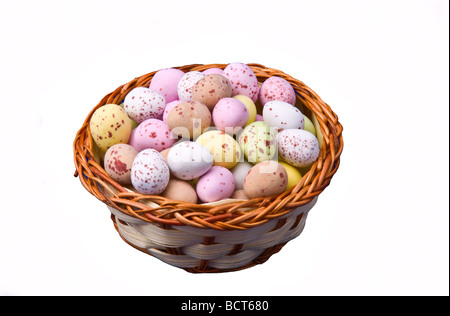 Mini easter eggs in a small basket. Stock Photo
