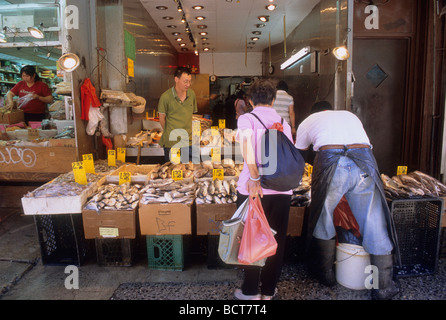 New York street food vendor on Canal Street in Chinatown. Neighborhood fishmonger and customer. Lower Manhattan, New York City USA. Stock Photo