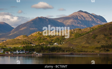 Shieldaig village from the Applecross road across Loch Sheildaig, with Beinn Damh behind Stock Photo