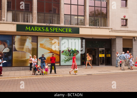 Marks and Spencer food store entrance in Norwich Norfolk Uk with people passing by Stock Photo