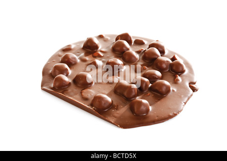 Round block of milk chocolate with whole hazelnuts Stock Photo