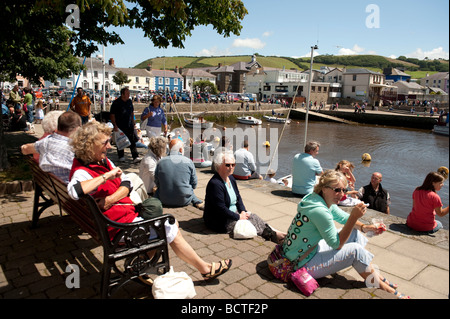 People sitting around the harbour in the sunshine during the 2009 Cardigan Bay Seafood festival Aberaeron Ceredigion Wales UK Stock Photo