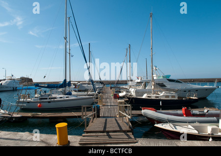 Yachts moored on the jetty at the Venetian harbour in Chania, Crete, Greece. Stock Photo