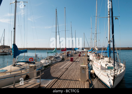 Yachts moored on the jetty at the Venetian harbour in Chania, Crete, Greece. Stock Photo