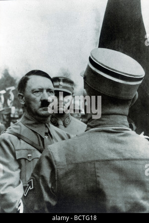 Adolf Hitler 'consecrating' new flags with the Blutfahne blood flag, behind him chief of staff Viktor Lutze, historical photo b