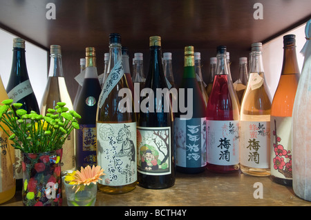 Saki bottles on display outside restaurant in Tokyo Japan Stock Photo