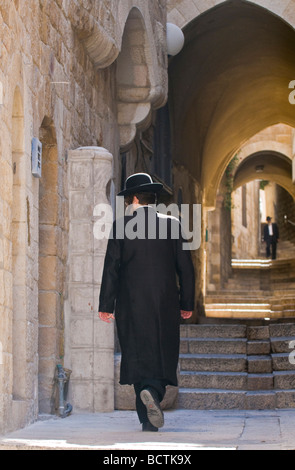 Orthodox jews walking in the street of old Jerusalem Stock Photo
