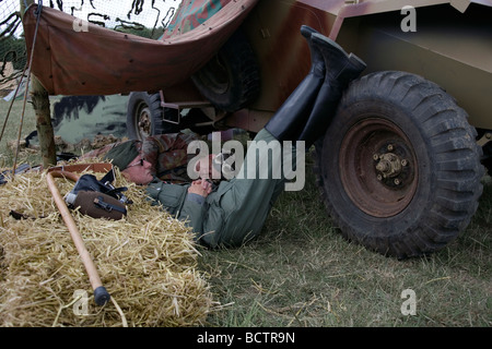 two men pretending to be german soldiers from world war 2 sleep at an event in kent, england Stock Photo
