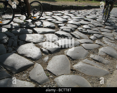 people riding bikes on the ancient roman old appian way, rome, italy Stock Photo