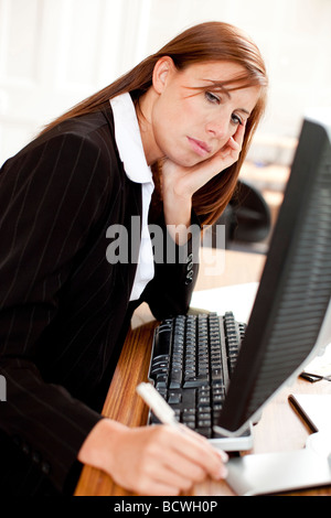 Woman stressed at computer Stock Photo