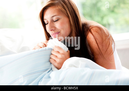 Girl smelling douvet Stock Photo