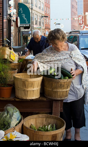 An elderly woman shops in an outdoor market in Boston's Italian North End. Stock Photo