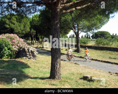 people riding bikes on the ancient roman old appian way, rome, italy Stock Photo