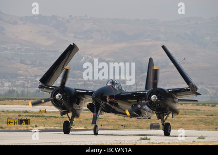 A Grumman Tigercat taxis on the runway with its wings folded up Stock Photo