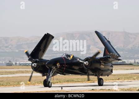 A Grumman Tigercat taxis on the runway with its wings folded up. Stock Photo