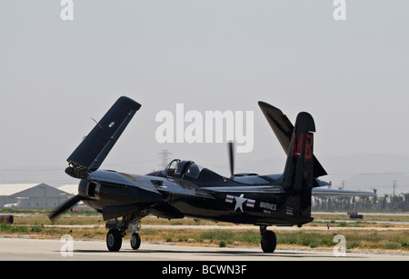 A Grumman Tigercat taxis on the runway with its wings folded up. Stock Photo