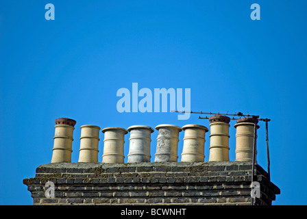 row of chimey pots on a rooftop of victorian homes in barnes, southwest london, england Stock Photo