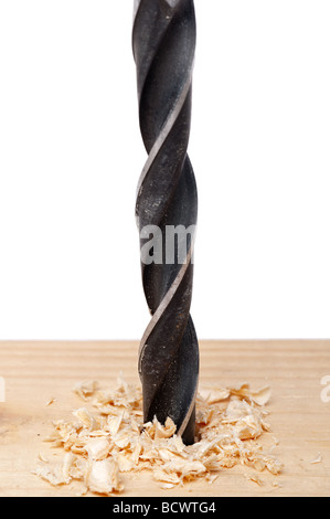 A vertical close up of a hole being bored into wood with a drill bit Stock Photo