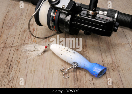 Fishing rod with baits and fishing hooks with baits on a brown background  Stock Photo - Alamy