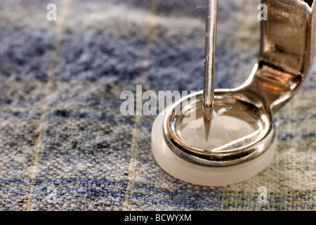 Sewing on a Shirt Button Stock Photo