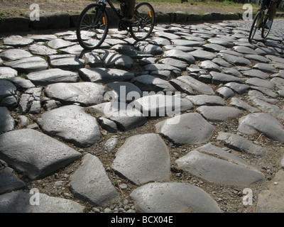 people riding bikes on the ancient roman old appian way, rome, italy Stock Photo