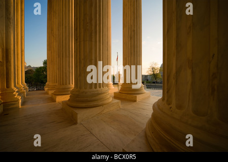 US Supreme Court building main entrance colonnade with American Flag in Washington DC USA. Stock Photo