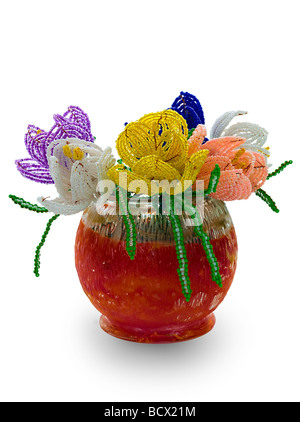 Handmade article: vase with flowers from glass beads and wire. Yellow, blue, pink, white bud. Green foliage. Red bowl. Stock Photo