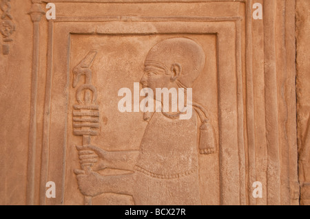 Egypt Kom Ombo temple wall carving relief hieroglyph man figure holds staff Stock Photo