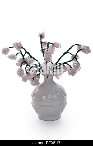 Handmade article: vase with flowers from glass beads and wire. White bud. Stock Photo