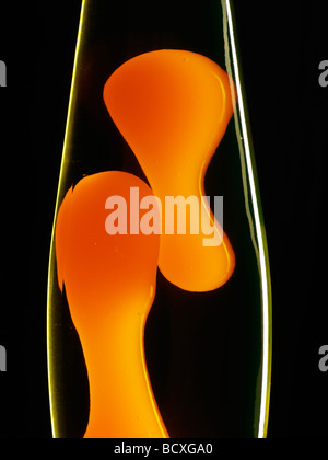 orange lava lamp against a black background Stock Photo