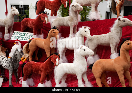 Raffle prizes on display on a market stall, soft toys Stock Photo - Alamy