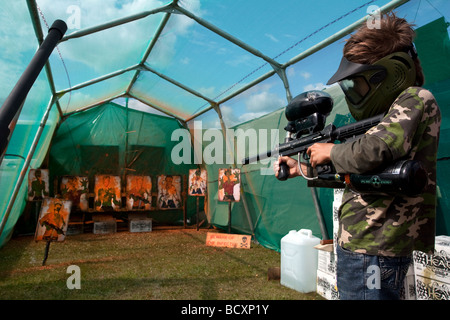 A boy is shown with a pellet gun on a mock firing range at the 5th Colchester Military Festival in Essex, England July 2009 Stock Photo
