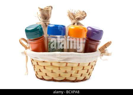 Assortment of spice jars for prepare tasty food in a basket over a white background Stock Photo