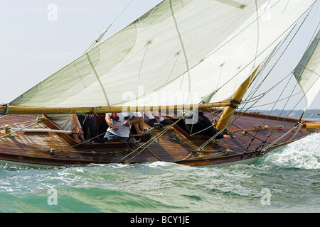 A heeled classic yacht sailing on the solent Stock Photo