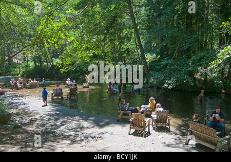 People sitting in the Big Sur river at the River Inn Stock Photo