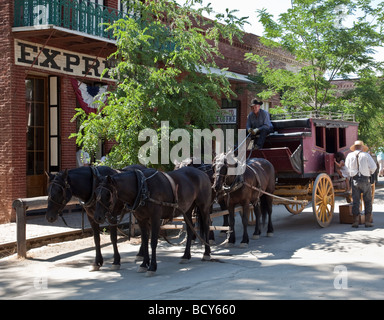 Tourists get aboard a horse-drawn stagecoach for a ride around the historic gold-rush town in Columbia Historic State Park Stock Photo