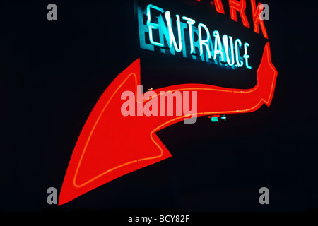 Neon entrance sign with red arrow Stock Photo