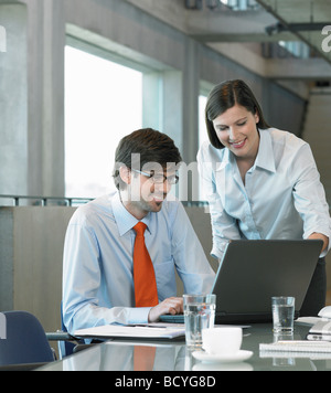 Two Businesspeople looking on laptop Stock Photo